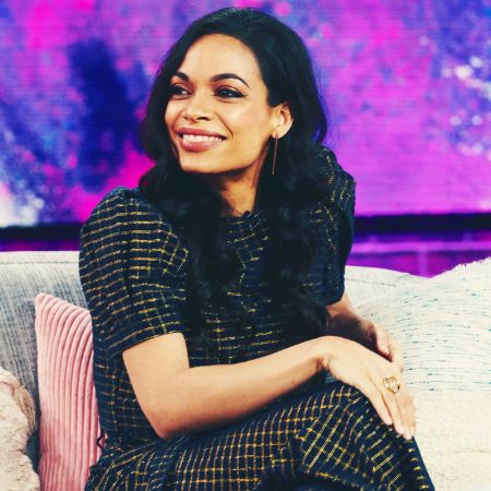 Rosario Dawson in a lovely black dress caught on camera during an interview.